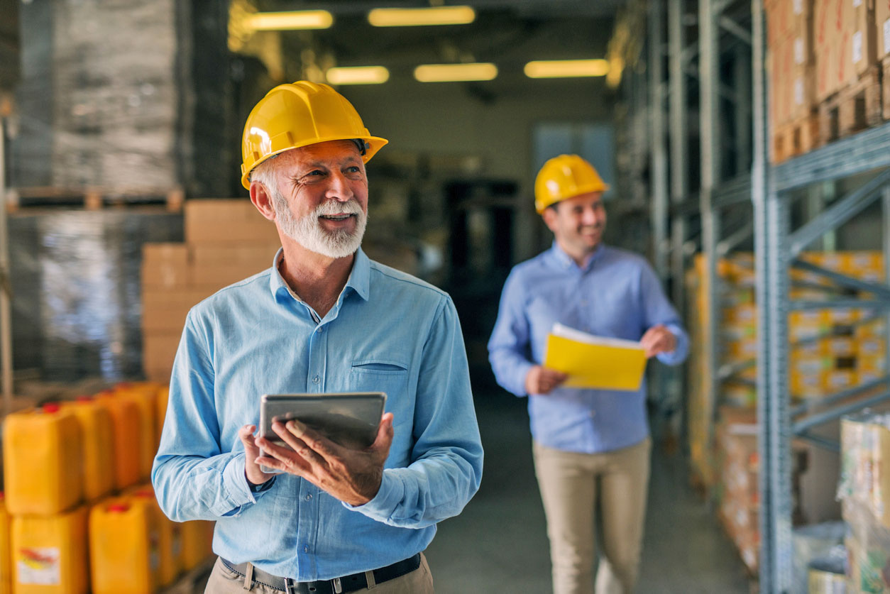 Two men walking through a warehouse