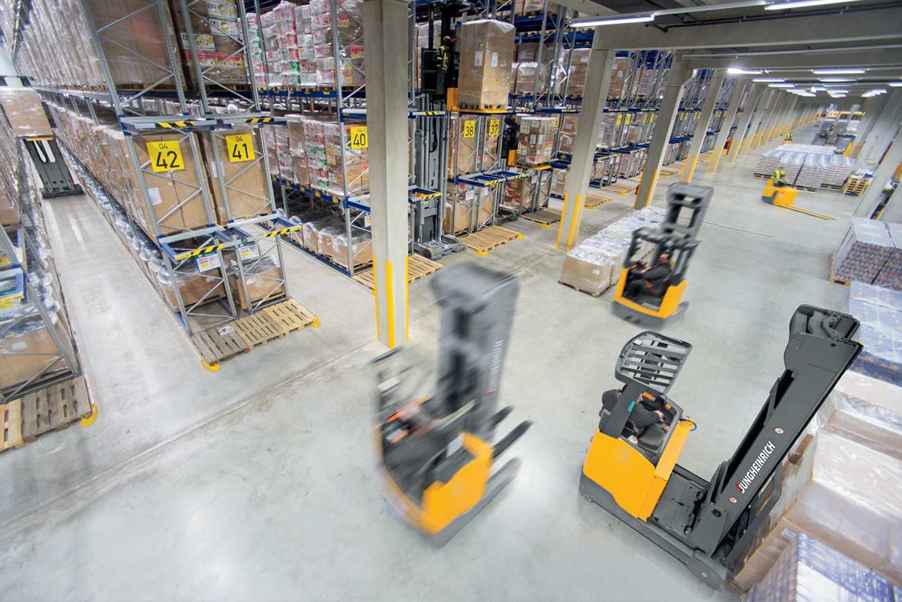 Forklifts moving in a warehouse