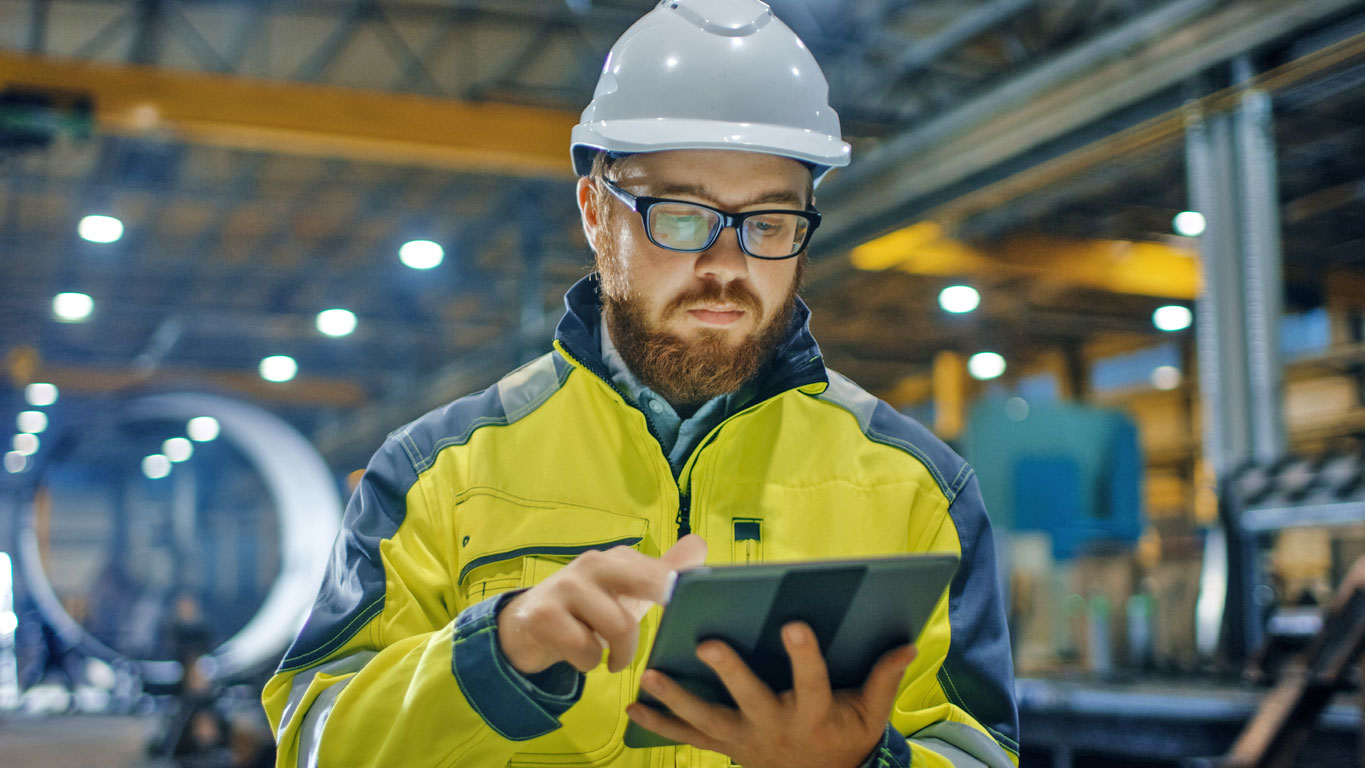 man on a tablet in a warehouse