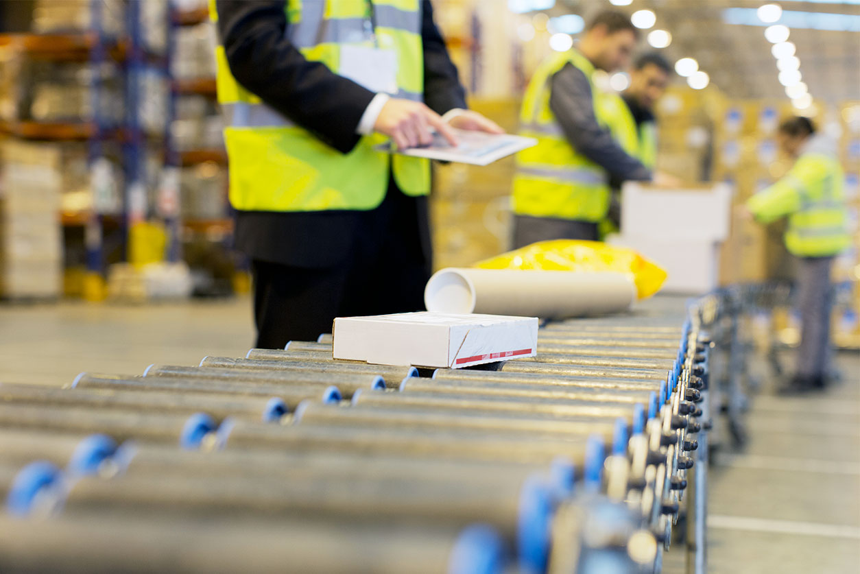 Warehouse conveyor with people working