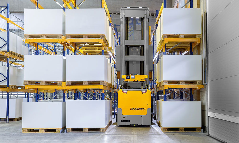 Jungheinrich AGV in between two rows of warehouse pallet racking