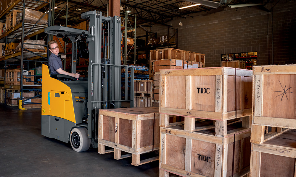 Man on electric rider forklift