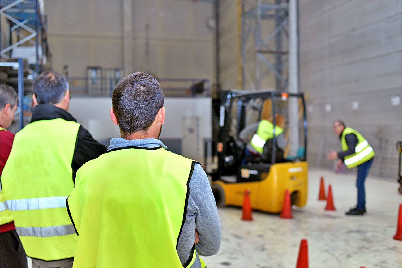 People doing forklift safety training in a warehouse